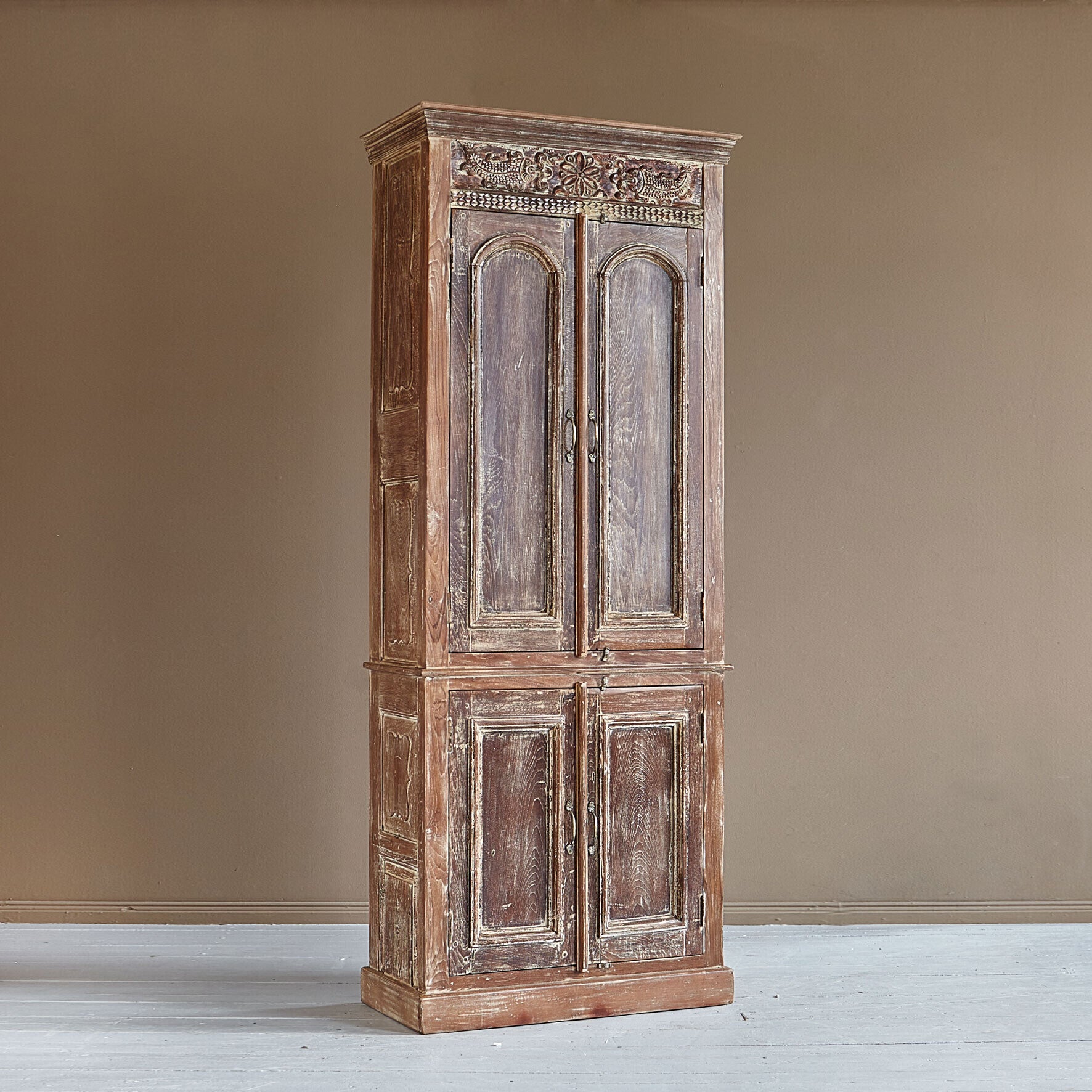 Vintage wooden wardrobe against a beige wall
