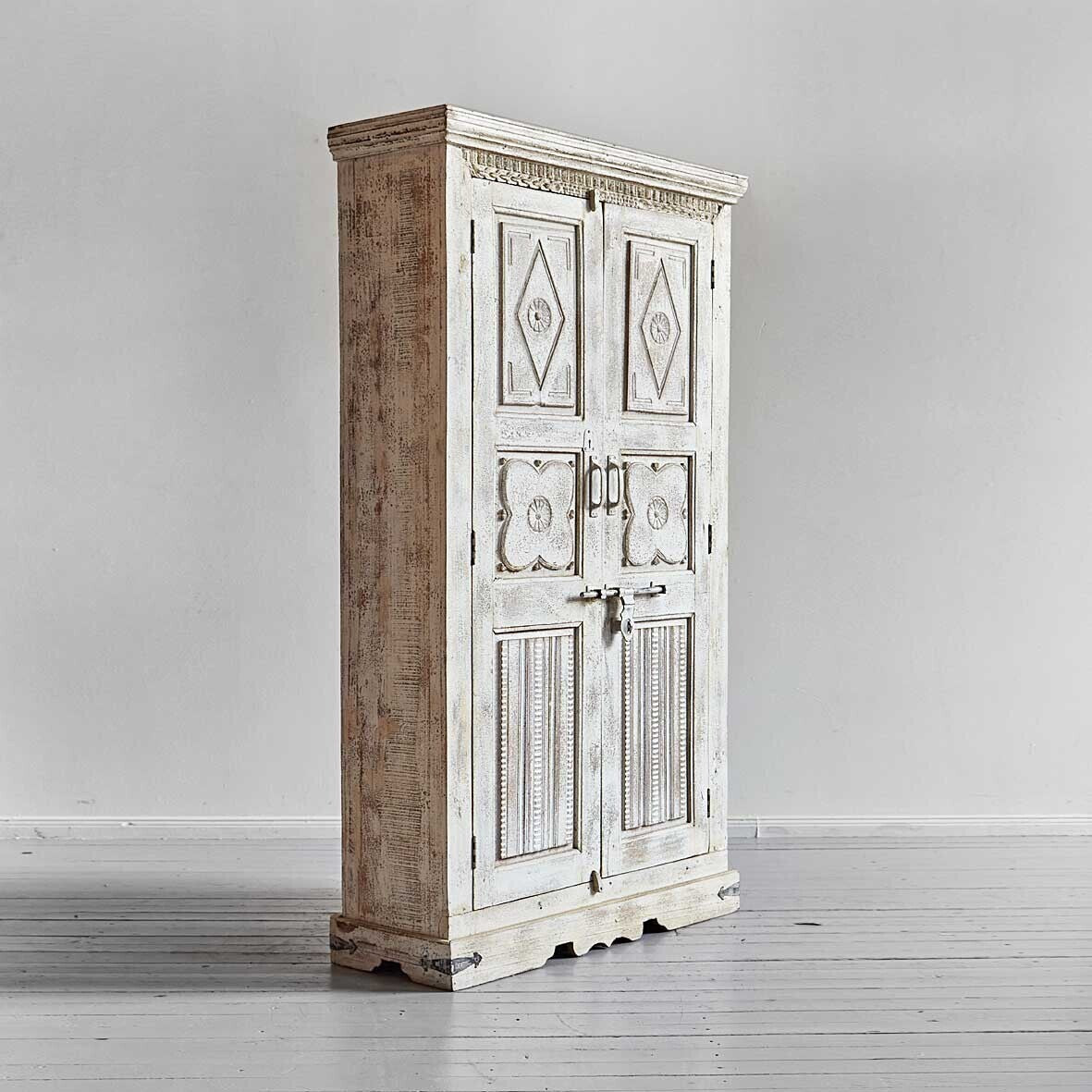 Vintage-style wooden cabinet with decorative doors on a plain background