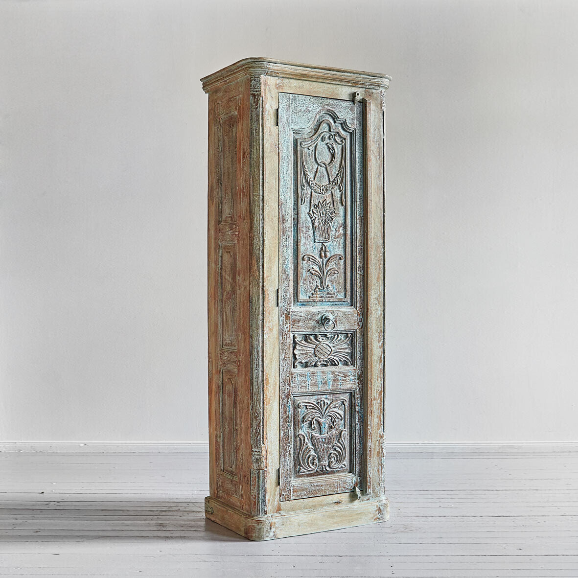 Vintage wooden cabinet with decorative carvings on a white background