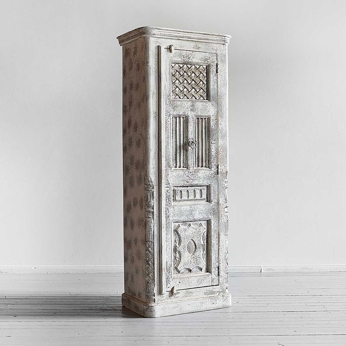 Vintage-style wooden cabinet with intricate carvings on a white background