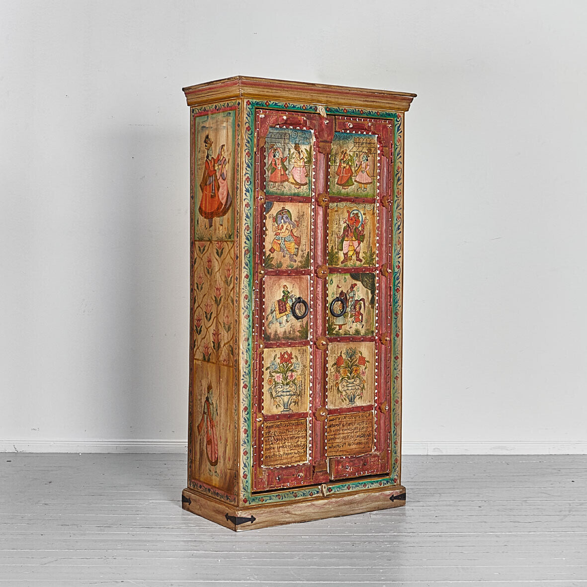 Decorative wooden cabinet with painted panels on a white background