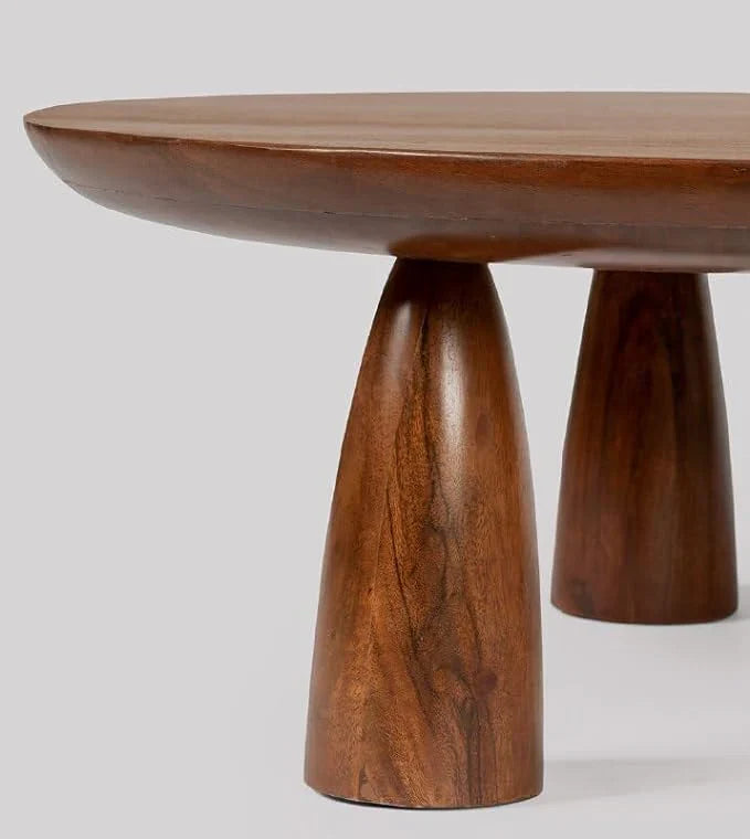 acacia wood coffee table, round coffee table, dark brown table, low coffee table, minimalist table, conical leg table, tapered leg table, scandinavian table, japanese table, modern table, indian furniture, living room table, statement coffee table, handmade coffee table, artisan made table, premium wood table, quality furniture, durable table, sturdy table, timeless table, elegant table, unique table, sculptural table, focal piece table, handcrafted in india, sustainable acacia wood, dark wood finish, natur