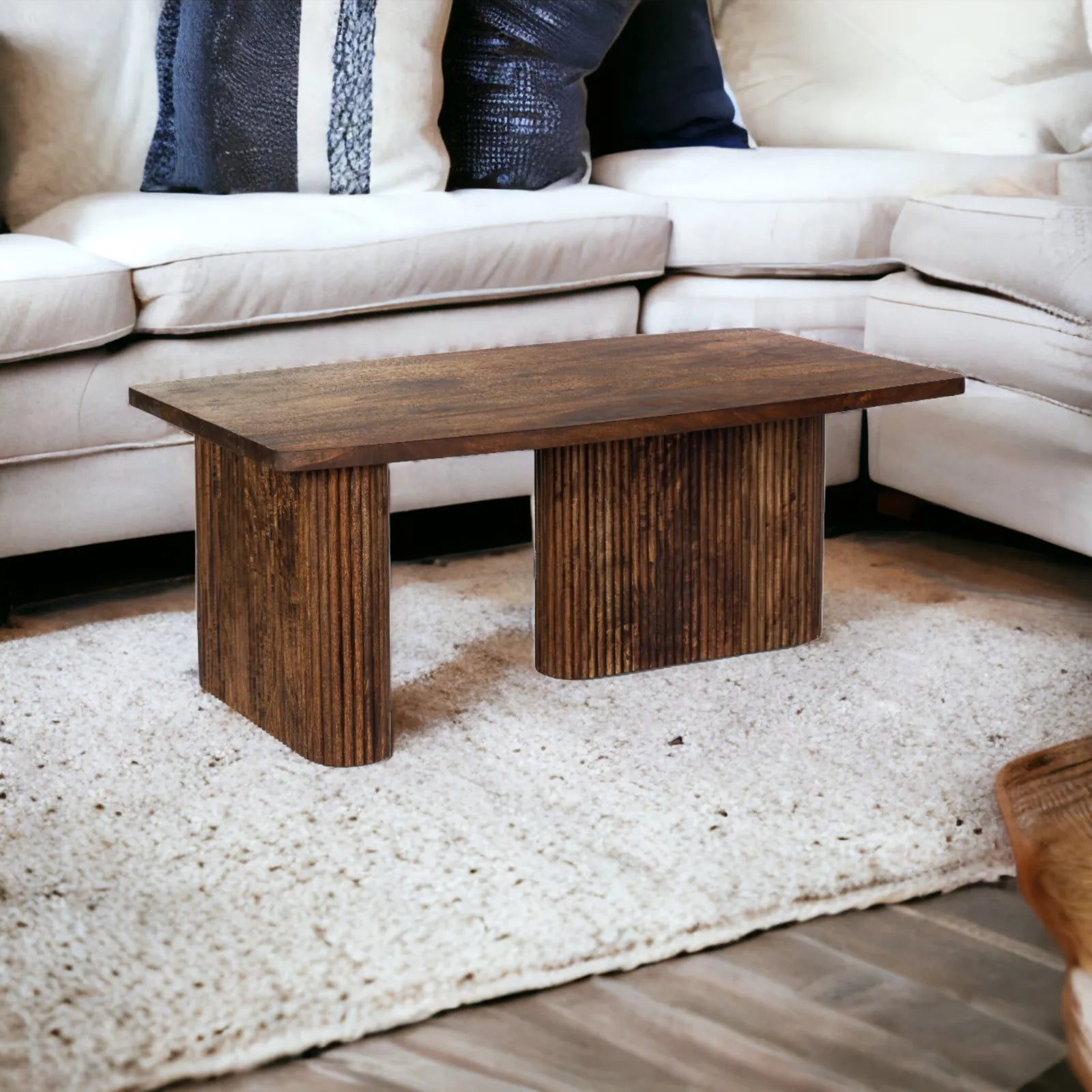 mango wood table, coffee table, rectangular table, tubaq finish table, fluted base table, curved panel table, sculptural table, modern table, mid century table, minimalist table, living room table, statement coffee table, handmade coffee table, artisan made table, premium wood table, quality furniture, durable table, sturdy table, timeless table, elegant table, unique table, sculptural base, focal piece table, handcrafted in india, sustainable mango wood, natural wood grain, tobacco brown finish, warm wood 