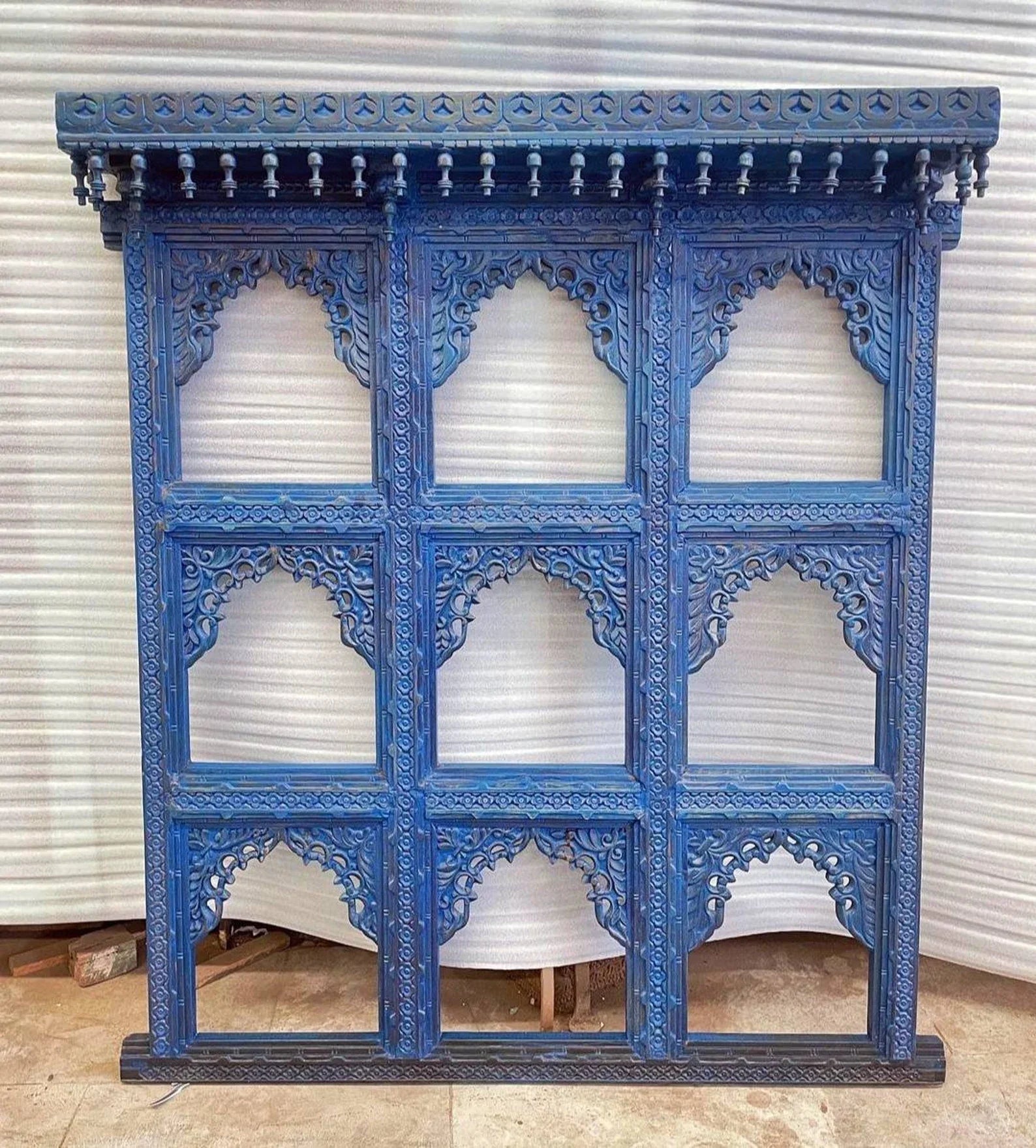 mango wood mirror, jharokha mirror, nine arch mirror, grid mirror panel, indian mirror, blue mirror, distressed blue, carved mirror, wall mirror, statement mirror, palace mirror, scalloped arches, foliate carving, rope border, vine border, baluster brackets, crown cornice, architectural decor, boho decor, global eclectic, vintage inspired, artisan made, handcrafted in india, solid wood frame, large wall mirror, square mirror, entryway decor, living room decor, dining wall, stair landing, heritage decor, ind