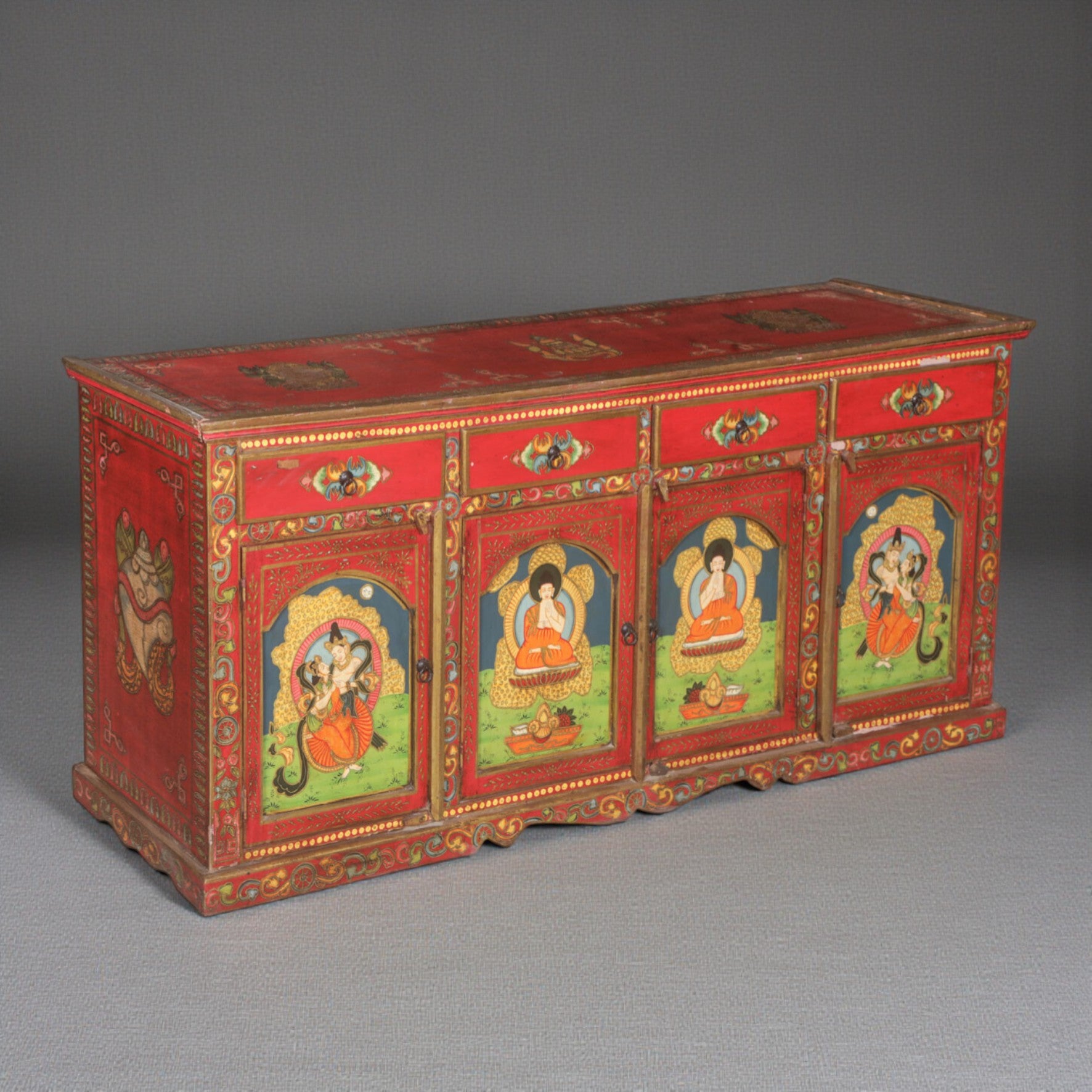 Decorative red cabinet with colorful artwork on a gray background