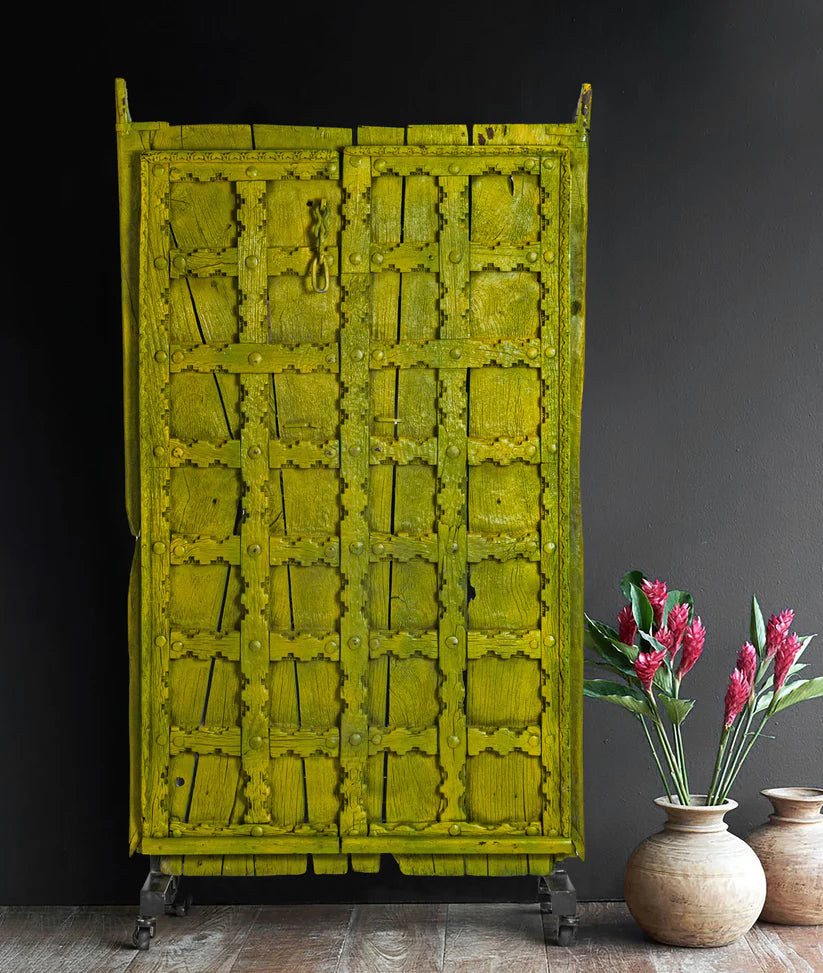 Unique Marwari wooden door with iron stand, distressed olive green finish, 94 × 171 cm.

Handcrafted solid wood Marwari door panel with grid pattern and castor base.

Tall antique-style Indian door decor in olive green, made in India.