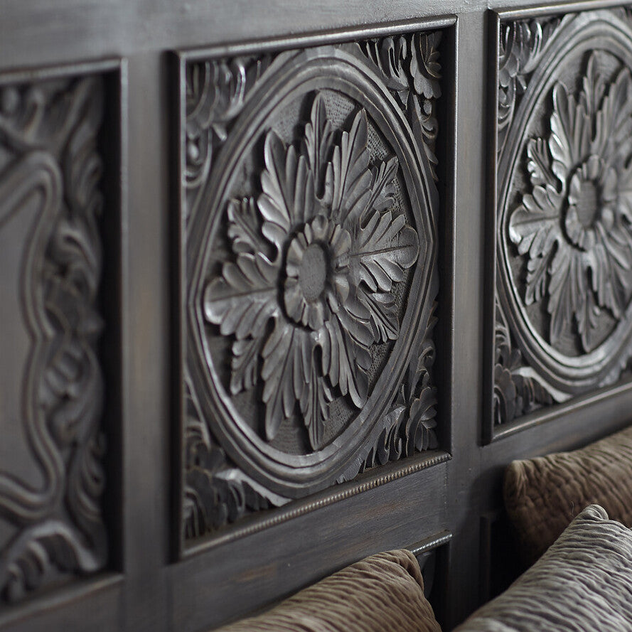 Decorative wall panels with floral patterns on a wooden surface.