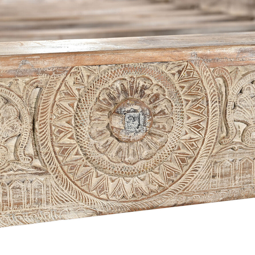 Carved wooden panel with intricate patterns on a white background