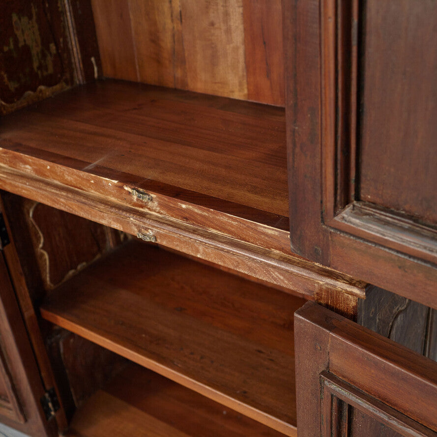 Close-up of an old wooden cabinet with a shelf.