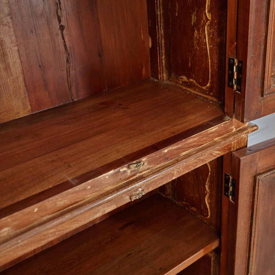 Close-up of an old wooden cabinet with visible wear and tear.