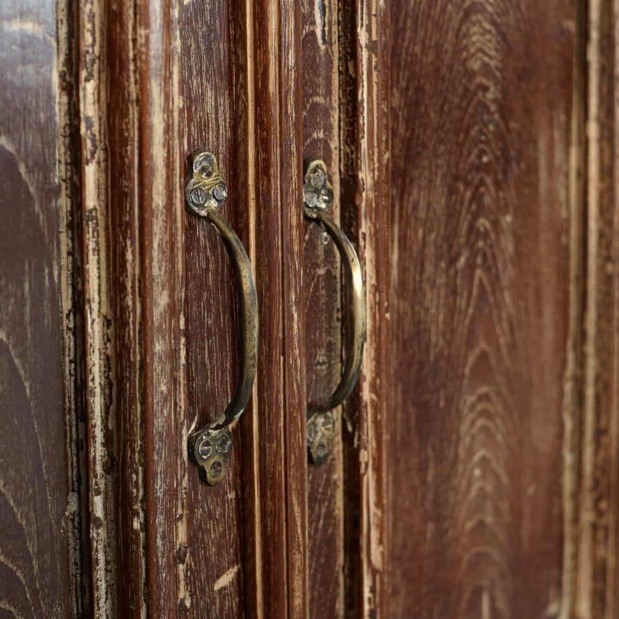 Close-up of a wooden door with brass handles