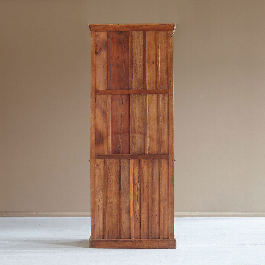 Wooden wardrobe against a beige wall