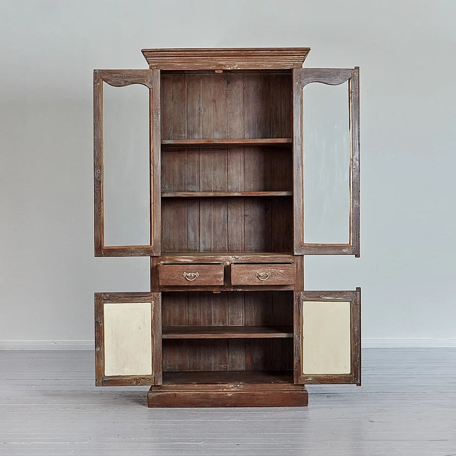 Wooden cabinet with open doors on a gray background
