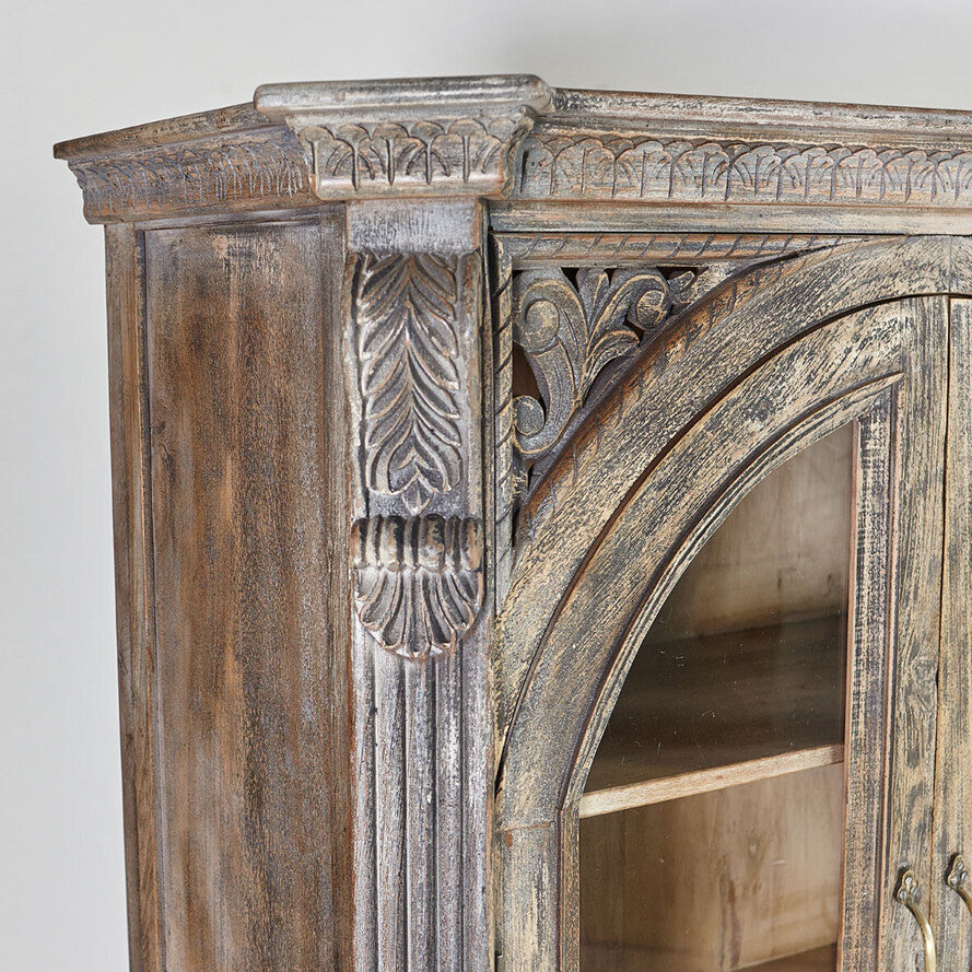 Wooden cabinet with intricate carvings on a white background