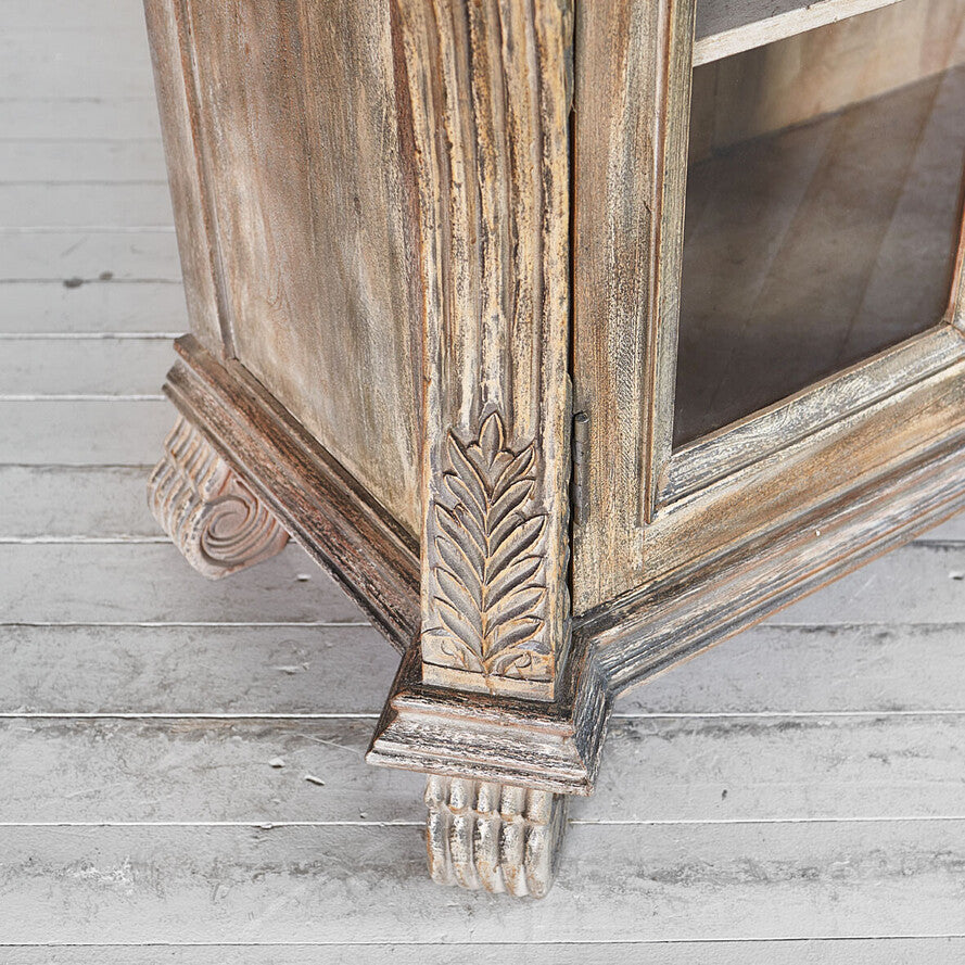 Wooden mirror with decorative carvings on a wooden floor