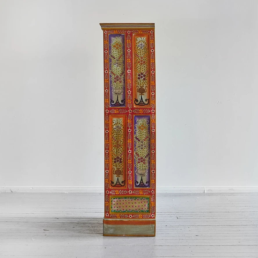 Decorative tall cabinet with floral patterns on a white background