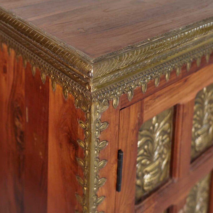 Close-up of a wooden cabinet with ornate gold detailing