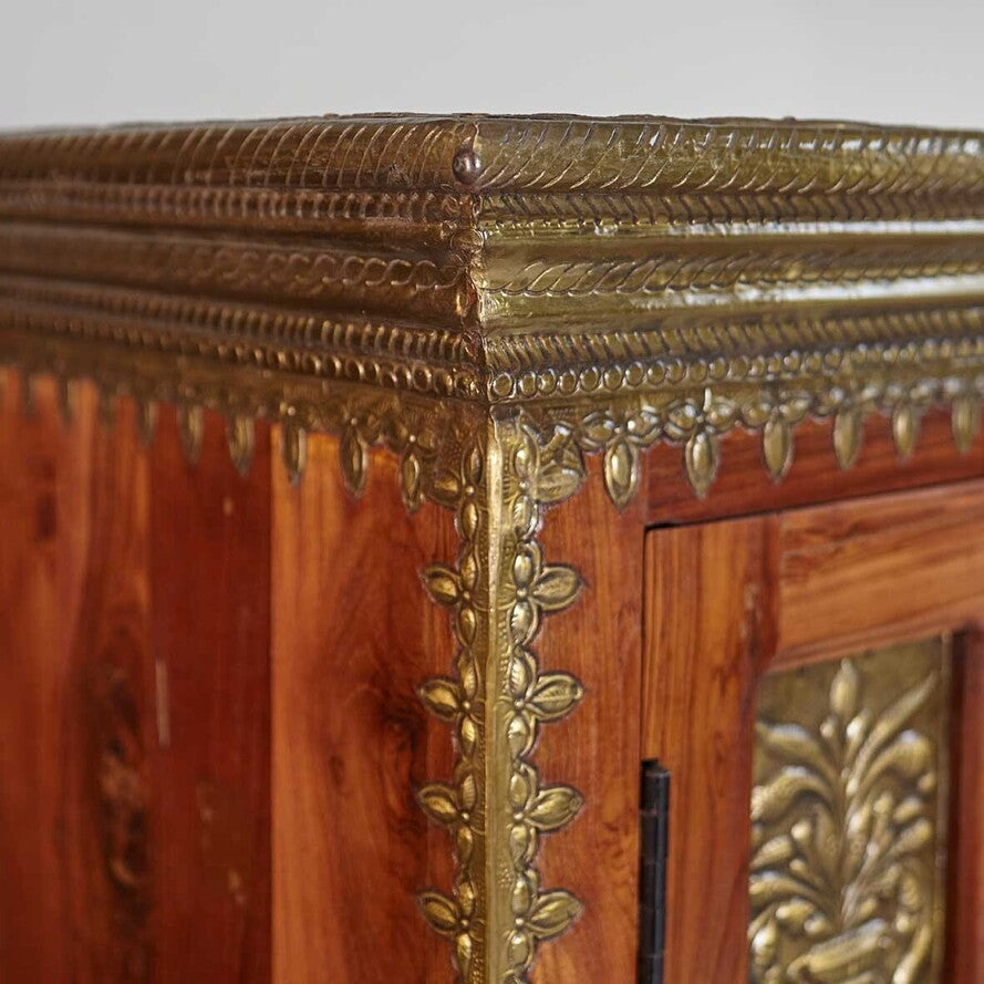 Close-up of a wooden cabinet with gold leaf detailing