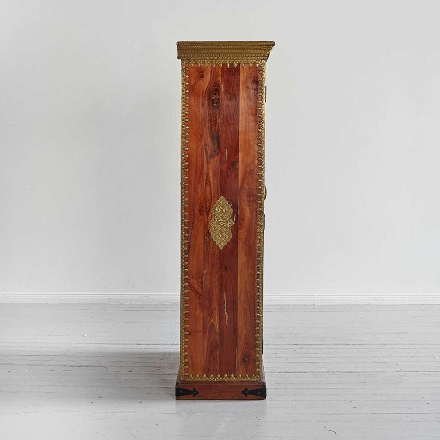 Wooden cabinet with gold accents on a white background