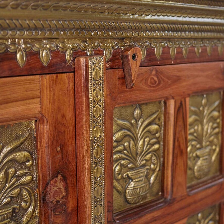 Close-up of an ornate wooden cabinet with gold leaf detailing