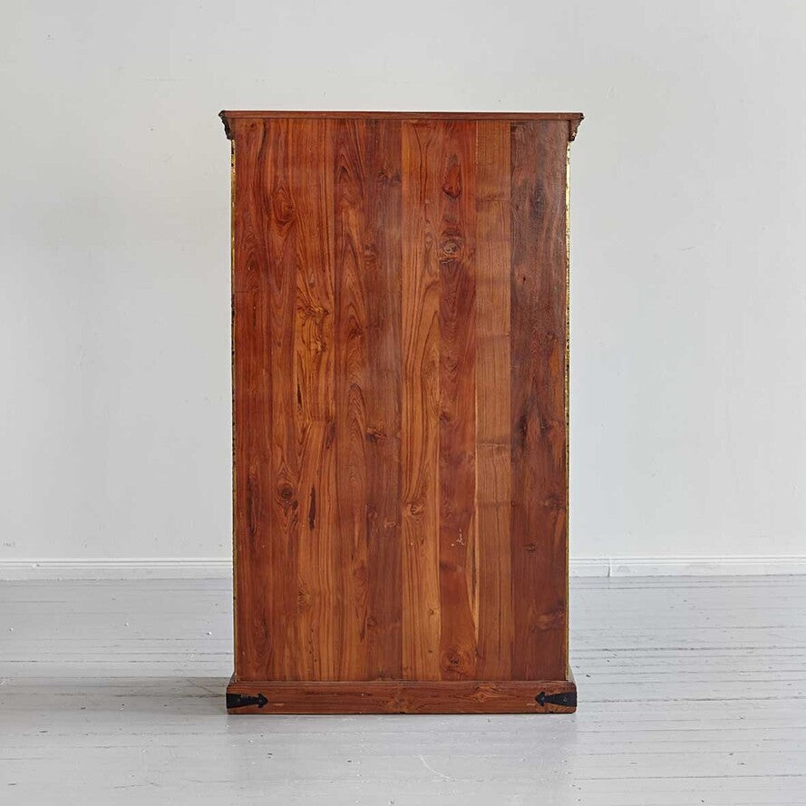 Wooden cabinet against a white wall
