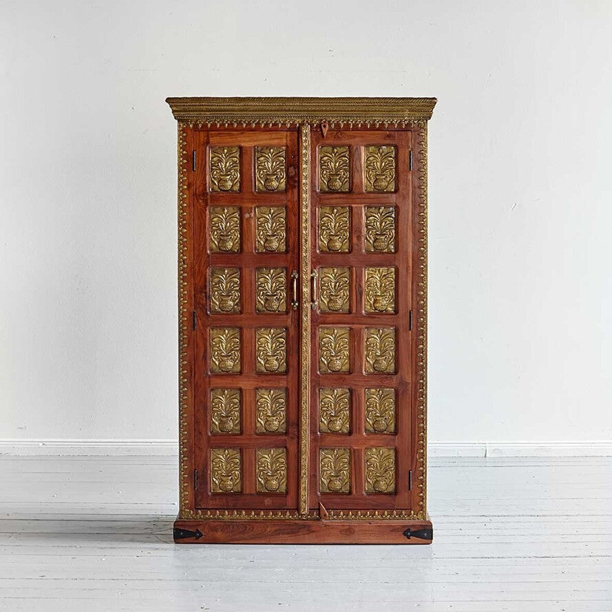 Wooden cabinet with gold leaf designs on a white background