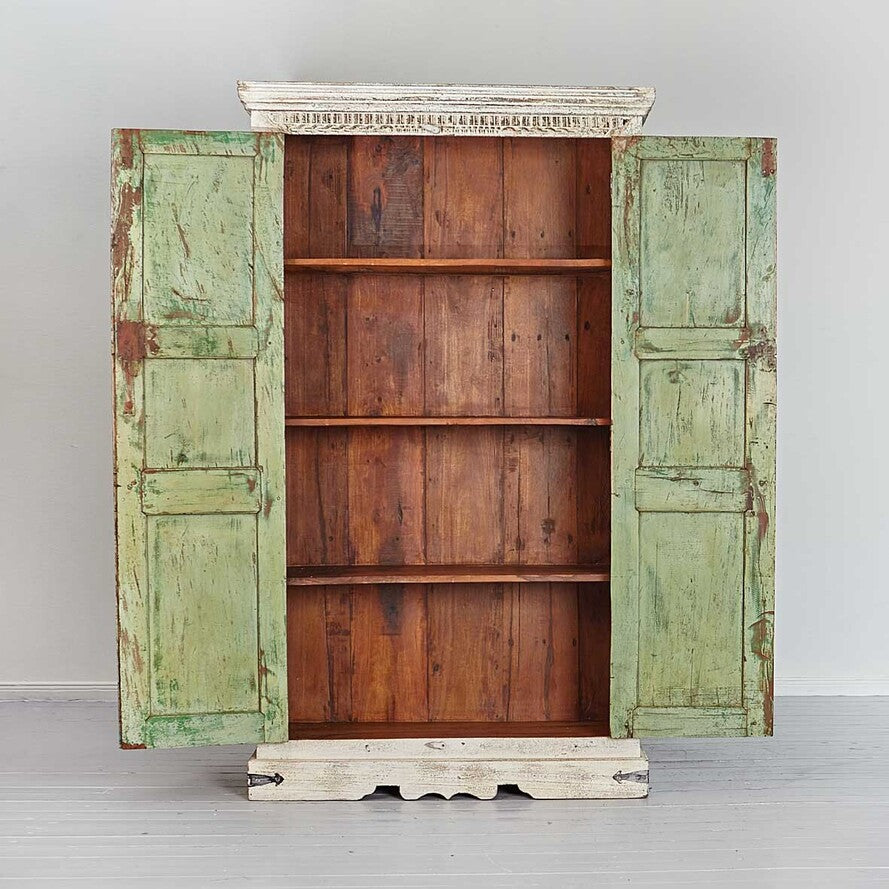 Wooden cabinet with green doors on a light gray background