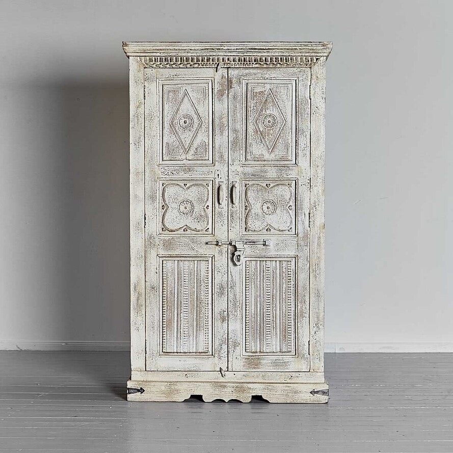 Vintage-style wooden cabinet with decorative carvings on a gray background
