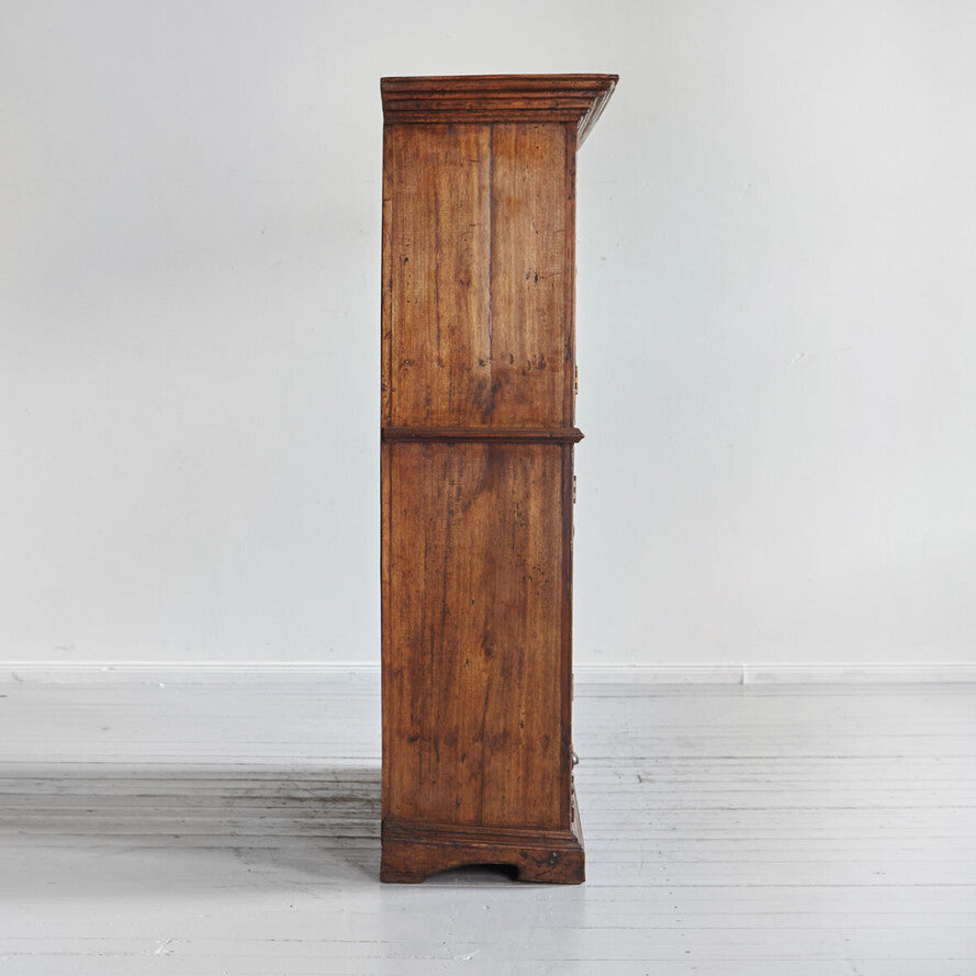 Wooden cabinet against a white wall