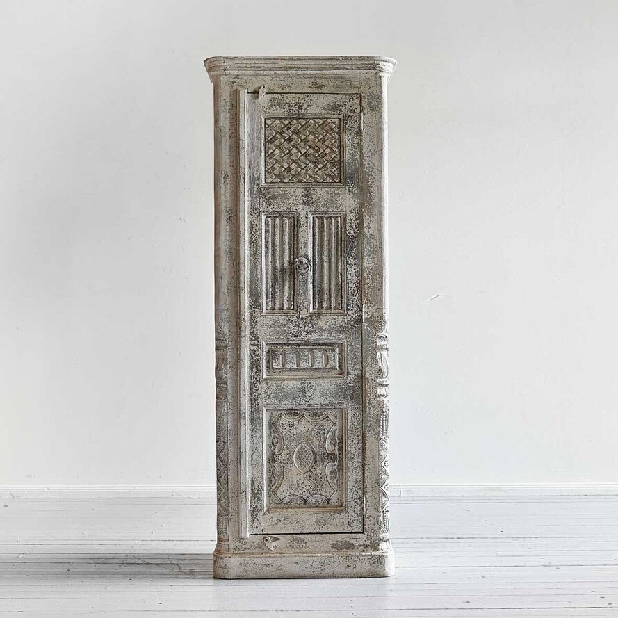 Decorative wooden cabinet with intricate carvings on a white background