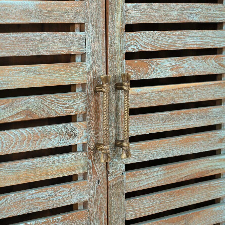 Wooden shutters with brass handles on a wooden door.