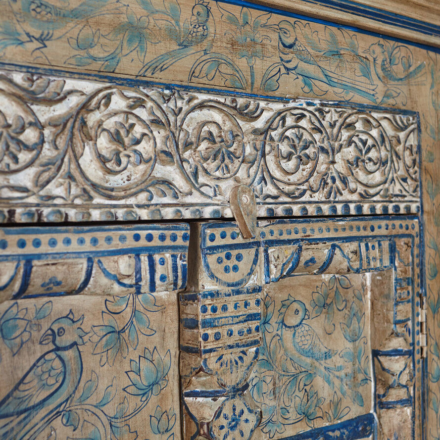 Decorative wooden panel with intricate carvings and blue paint