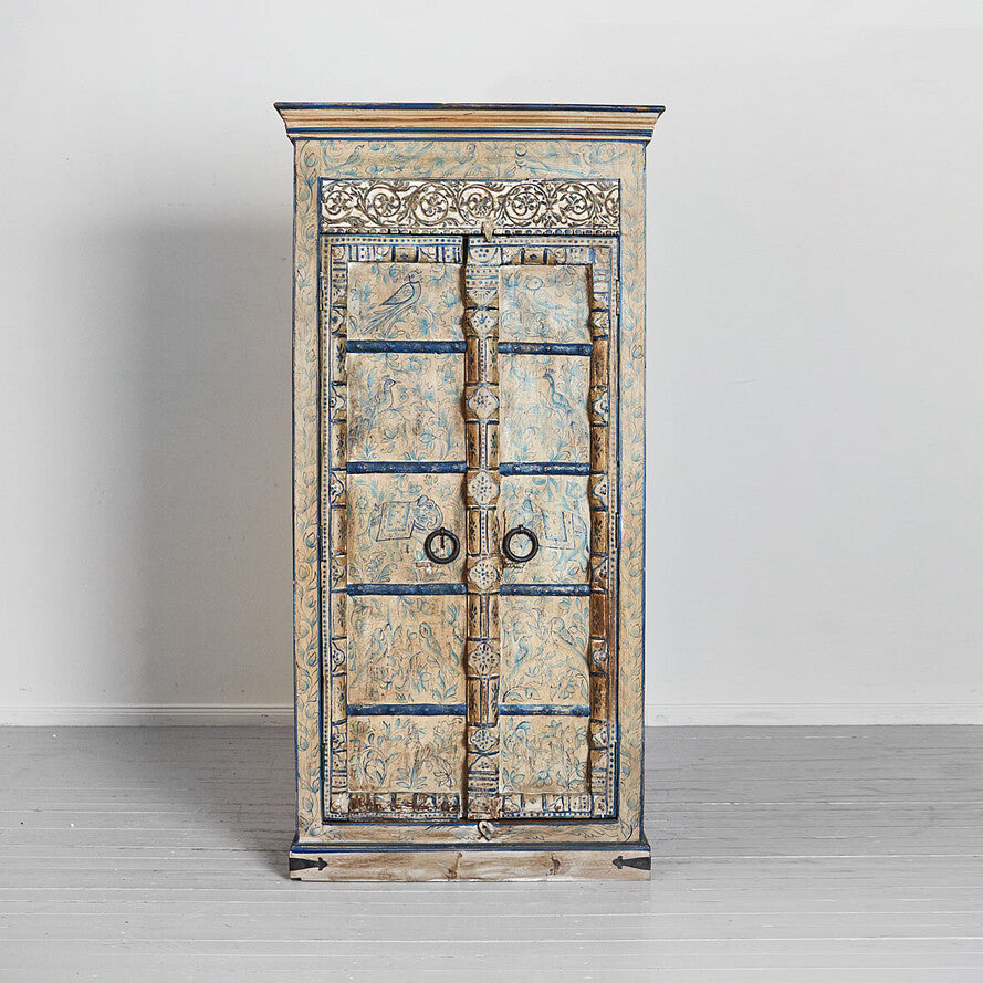 Decorative cabinet with intricate carvings on a plain background