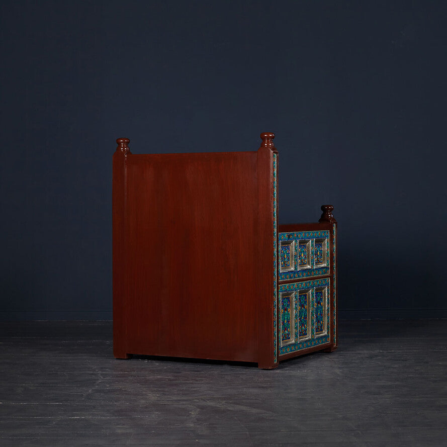 Wooden cabinet with turquoise and white patterned doors on a dark background