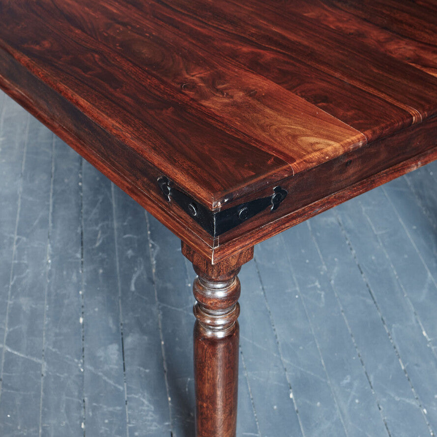 Wooden table with a dark finish on a gray floor