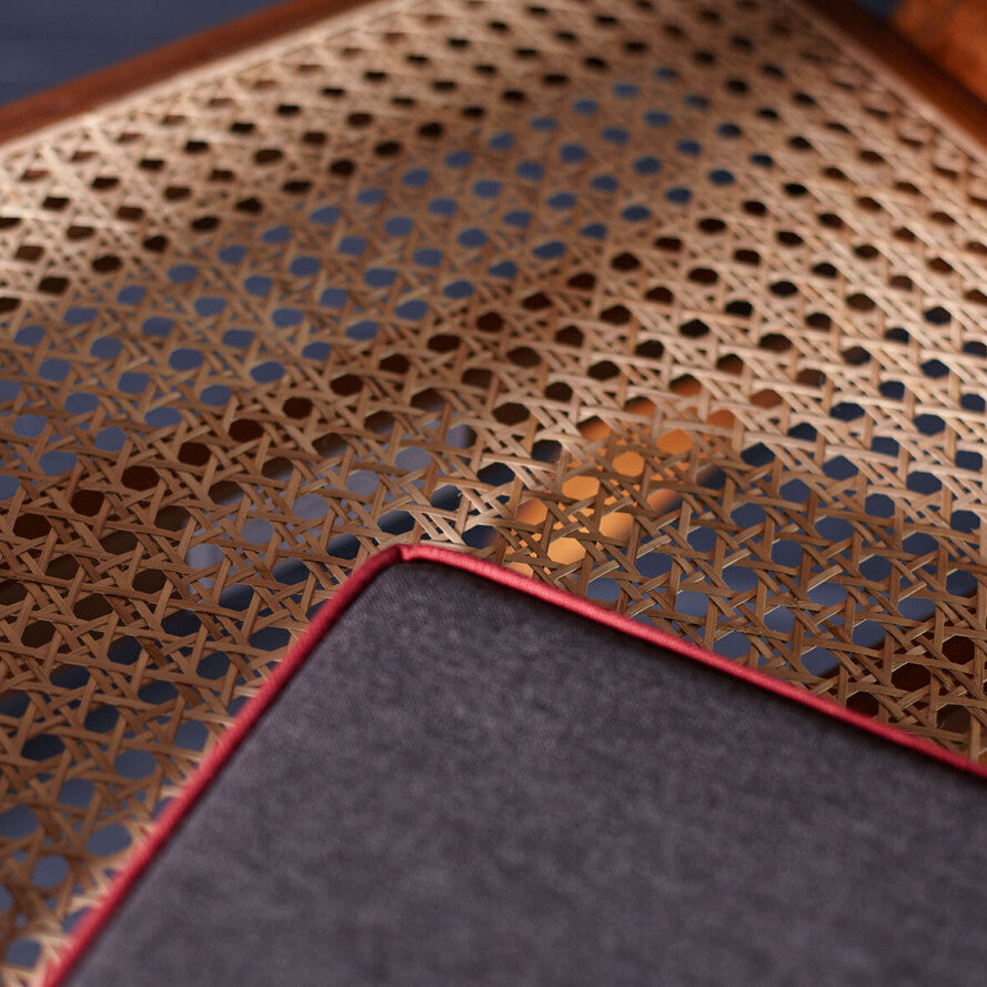 Close-up of a textured surface with geometric pattern and dark gray fabric corner.