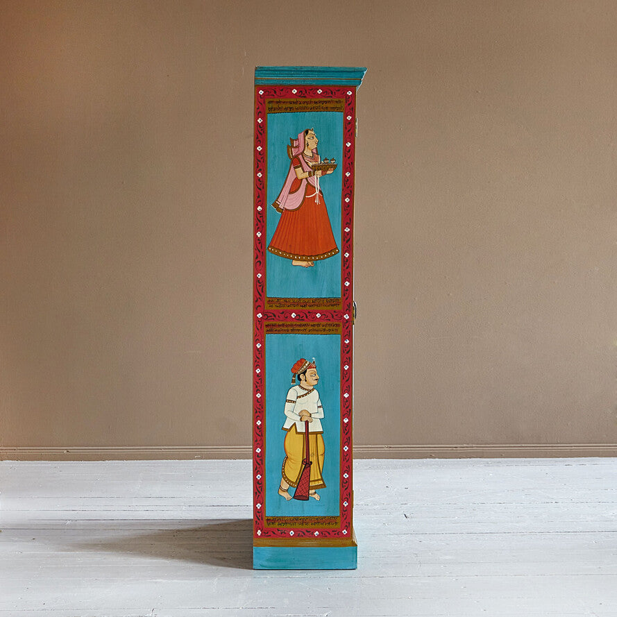 Decorative cabinet with painted figures on a beige wall background