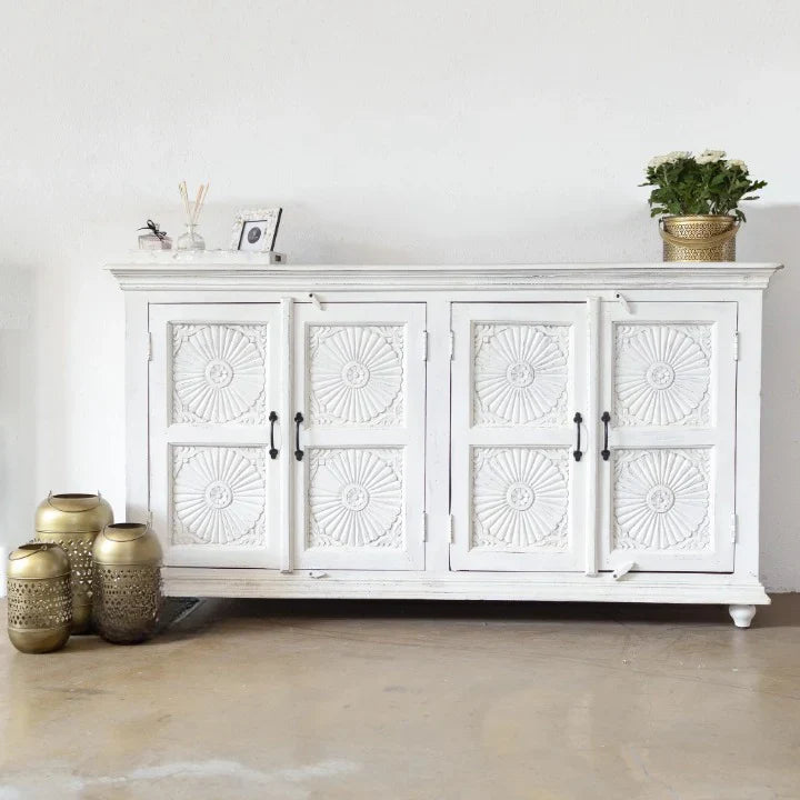 hand carved sideboard, mango wood sideboard, all white sideboard, white sideboard, floral carved sideboard, openwork sideboard, 4 door sideboard, 4 drawer sideboard, buffet sideboard, indian carved furniture, storage sideboard, dining room buffet, living room sideboard, entryway sideboard, statement sideboard, large sideboard, handmade sideboard, artisan made sideboard, premium wood buffet, quality wood furniture, durable sideboard, sturdy buffet, timeless sideboard, elegant buffet, grand sideboard, heirloo