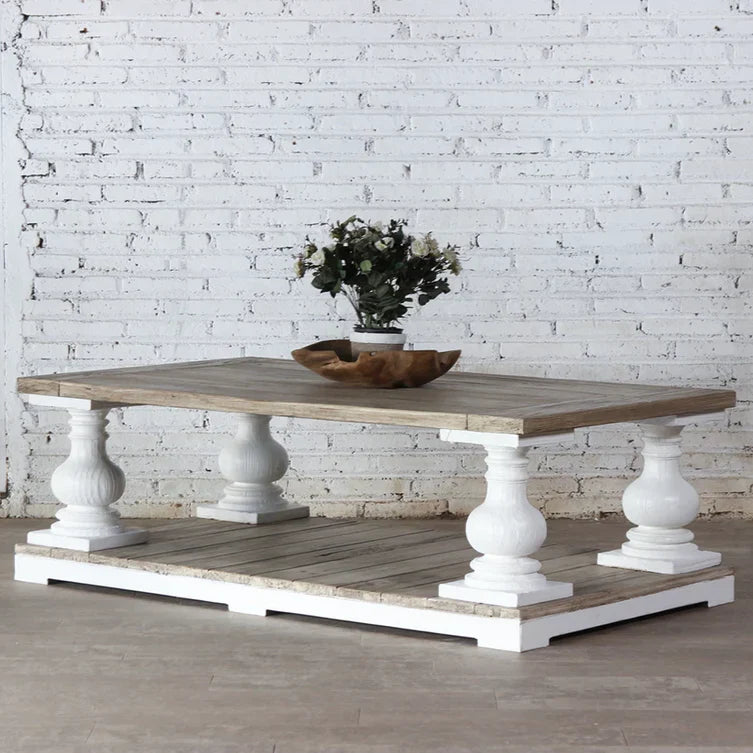 solid mango wood table, white coffee table, turned leg table, pillar leg table, two tier coffee table, coastal coffee table, large coffee table, rectangular coffee table, indian furniture, living room table, statement coffee table, handmade coffee table, artisan made table, premium wood table, quality furniture, durable table, sturdy table, timeless table, elegant table, classic table, unique table, focal piece table, handcrafted in india, sustainable mango wood, white painted legs, natural wood top, weathe