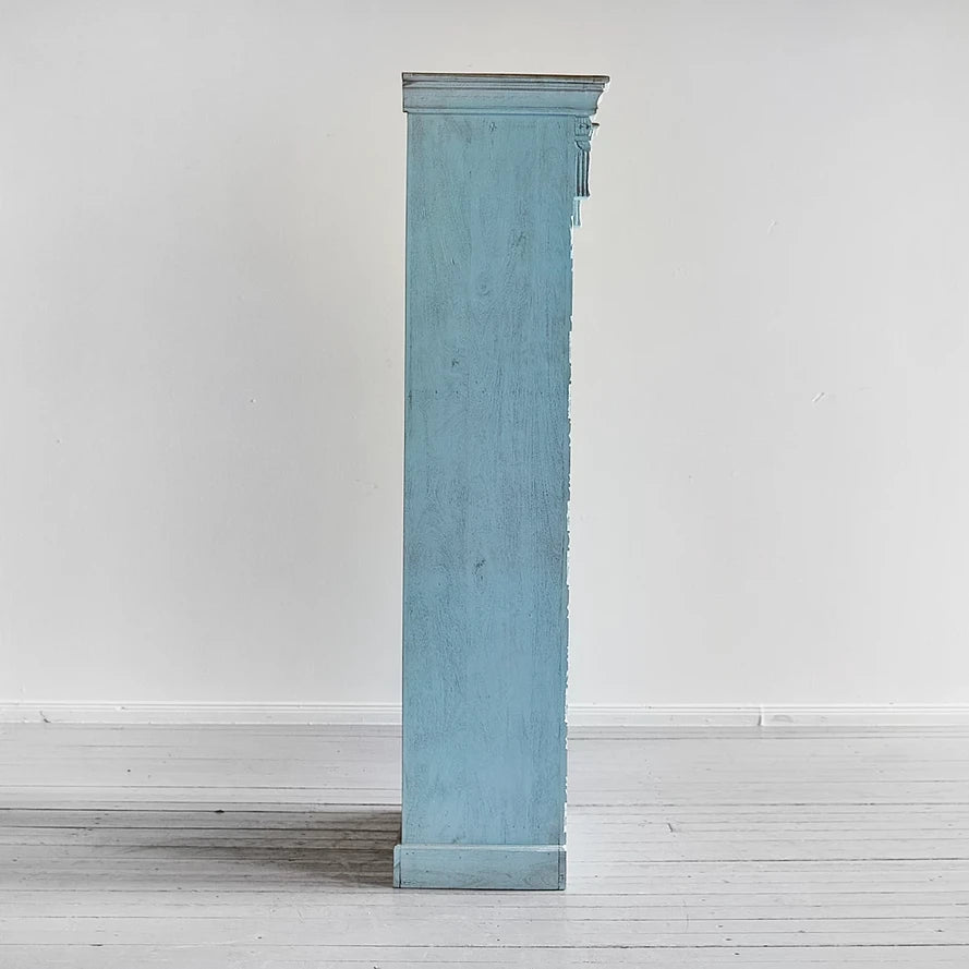 Light blue fireplace mantel against a white wall